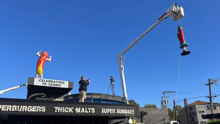 Superdawg's 12-foot-tall rooftop statues — “Maurie” and “Flaurie” — were removed Wednesday for a little buffing and polishing. (Superdawg / Facebook)