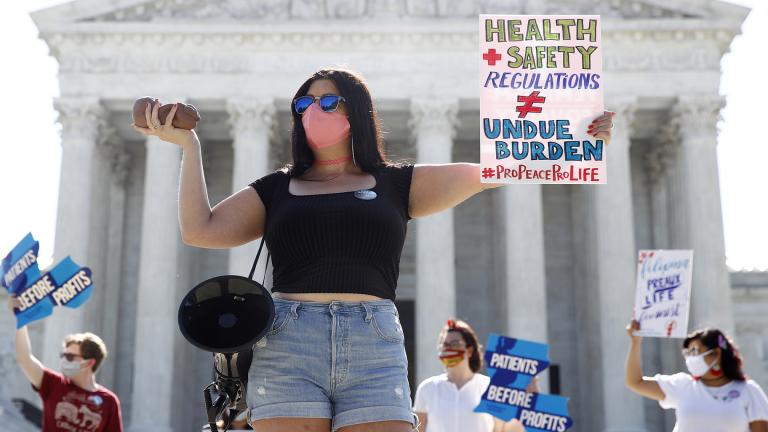 Terrisa Bukovinac, founder of Pro-Life San Francisco, holds a model of a fetus as she and other anti-abortion protesters wait outside the Supreme Court for a decision, Monday, June 29, 2020. (AP Photo / Patrick Semansky)
