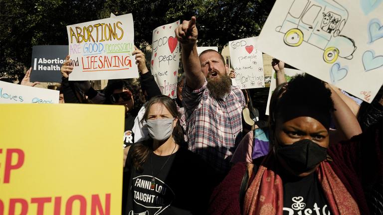 Allen Siders, an anti-abortion activist, center, calls out to speakers at an abortion rights rally in Jackson, Miss., Wednesday, Dec. 1, 2021. A small group of anti-abortion activists attempted to disrupt the gathering of participants from various abortion rights groups. The U.S. Supreme Court on Wednesday heard a Mississippi case that directly challenges the constitutional right to an abortion established nearly 50 years ago. (AP Photo / Rogelio V. Solis)
