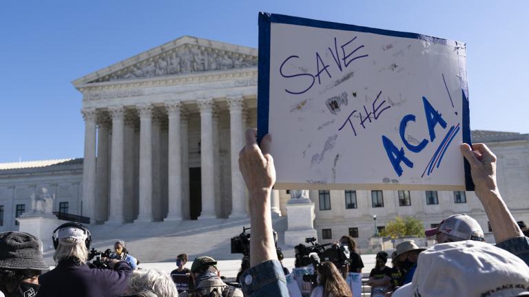 A demonstrator holds a sign in front of the U.S. Supreme Court as arguments are heard about the Affordable Care Act, Tuesday, Nov. 10, 2020, in Washington. (AP Photo / Alex Brandon)