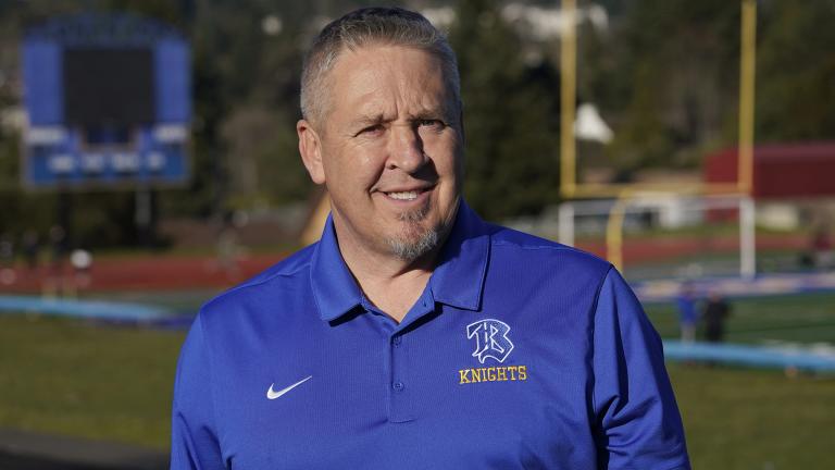 Joe Kennedy, a former assistant football coach at Bremerton High School in Bremerton, Wash., poses for a photo March 9, 2022, at the school's football field. (AP Photo / Ted S. Warren, File)