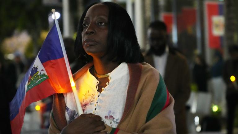 Linda Joseph holds a candle during a vigil at the Little Haiti Cultural Complex after a federal judge blocked the Trump administration from ending temporary immigration status, or TPS, for Haitians, Tuesday, Feb. 3, 2026, in North Miami. (AP Photo / Lynne Sladky, File)