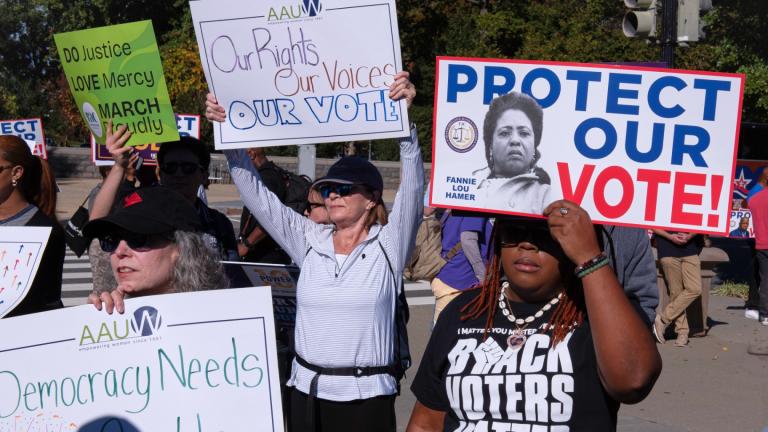 Voting rights activists gather outside the Supreme Court in Washington, early Wednesday, Oct. 15, 2025, as the justices prepare to take up a major Republican-led challenge to the Voting Rights Act, the centerpiece legislation of the Civil Rights Movement. (AP Photo / Cliff Owen)