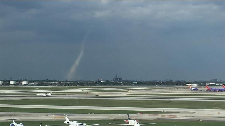 A landspout can be seen off in the distance Tuesday just outside Midway Airport. The brief tornado was Chicago's first since 2006. (Courtesy of Melanie Harnacke)