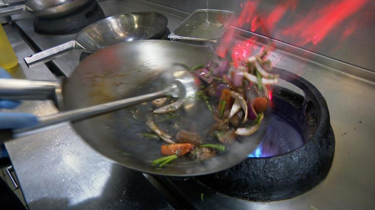 Executive chef Jesus Delgado prepares lomo saltado. (WTTW News) Executive chef Jesus Delgado prepares lomo saltado. (WTTW News)