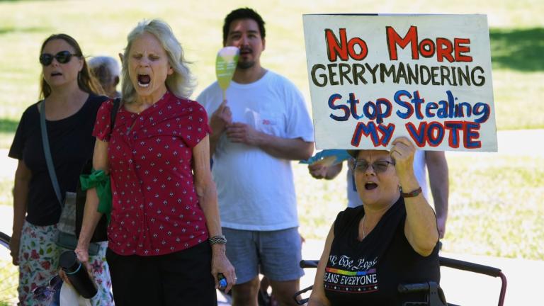 A woman holds a sign as she joins others during a rally to protest against redistricting hearings at the Texas Capitol, Thursday, July 24, 2025, in Austin, Texas. (AP Photo / Eric Gay)