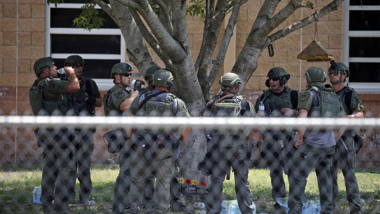 Law enforcement personnel stand outside Robb Elementary School following a shooting, May 24, 2022, in Uvalde, Texas.  (AP Photo / Dario Lopez-Mills, File)