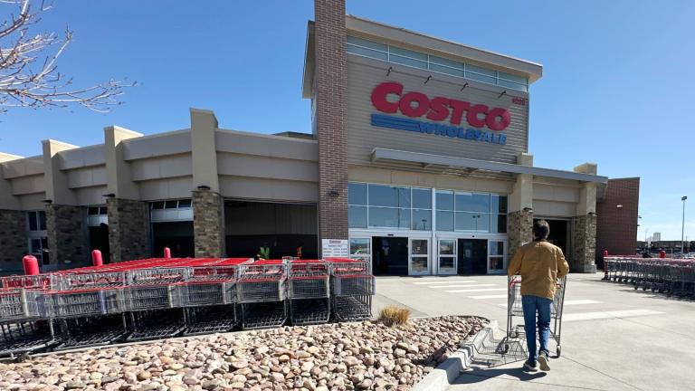 A lone shopper pushes a cart toward the entrance of a Costco warehouse, March 13, 2025, in Sheridan, Colo. (AP Photo/David Zalubowski, File)