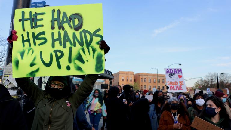 Protester Natalia Sustaita holds a sign reading “He Had His Hands Up!” at a Logan Square protest April 16, 2021, over the fatal police shooting of 13-year-old Adam Toledo. “I feel it’s important to show solidarity with Adam Toledo because he was just a child,” Sustaita said. “And if the money and resources that are given to the Chicago Police Department would’ve been used to fund the community of Little Village, maybe the situation would’ve been different.” (Evan Garcia / WTTW News)