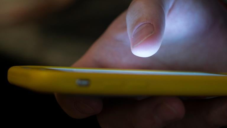 FILE - A man uses a cell phone in New Orleans on Aug. 11, 2019. (AP Photo / Jenny Kane, File)