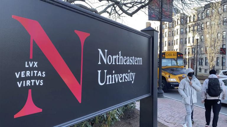 In this Jan. 31, 2019 file photo, pedestrians walk near a Northeastern University sign on the school’s campus in Boston. (AP Photo / Rodrique Ngowi, File)