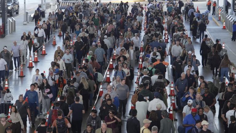 Travelers line up at a TSA checkpoint at George Bush Intercontinental Airport in Houston, Thursday, March 26, 2026. (AP Photo / Lekan Oyekanmi)