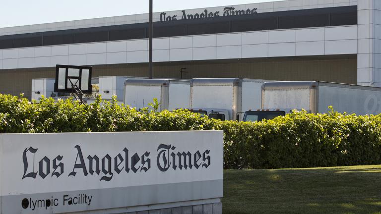 Delivery trucks are parked outside the Los Angeles Times Olympic Facility in Los Angeles, Sunday, Dec. 30, 2018. A computer virus hit the newspaper printing plant in Los Angeles, and at Tribune Publishing newspapers across the country. (AP Photo / Damian Dovarganes)