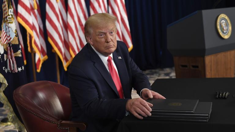 President Donald Trump prepares to sign four executive orders during a news conference at the Trump National Golf Club in Bedminster, N.J., Saturday, Aug. 8, 2020. (AP Photo/Susan Walsh)