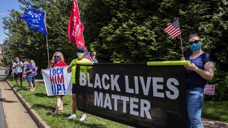 Supporters of President Donald Trump and protesters hold banners as they wait for the motorcade of President Trump outside the Trump National Golf Club in Sterling, Va., Sunday, Aug. 30, 2020. (AP Photo / Manuel Balce Ceneta)