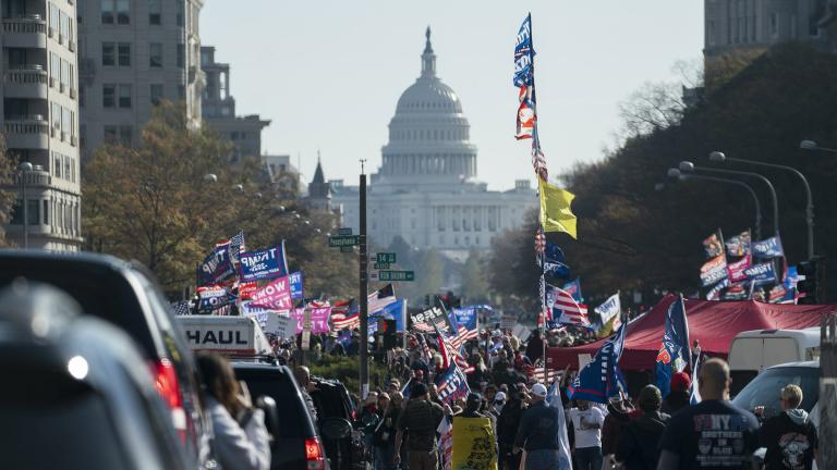 A motorcade carrying President Donald Trump drives by a group of supporters participating in a rally near the White House, Saturday, Nov. 14, 2020, in Washington. (AP Photo / Evan Vucci)