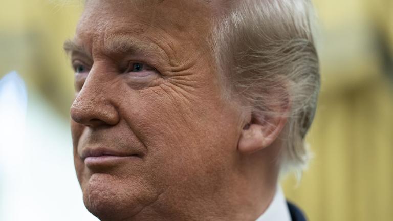 President Donald Trump listens during a ceremony to present the Presidential Medal of Freedom to former football coach Lou Holtz, in the Oval Office of the White House, Thursday, Dec. 3, 2020, in Washington. (AP Photo / Evan Vucci)