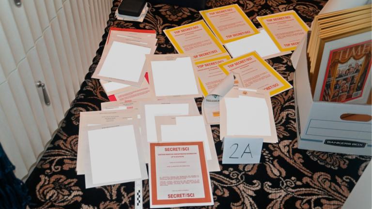 This image contained in a court filing by the Department of Justice on Aug. 30, 2022, and redacted by in part by the FBI, shows a photo of documents seized during the Aug. 8 search by the FBI of former President Donald Trump’s Mar-a-Lago estate in Florida. (Department of Justice via AP)