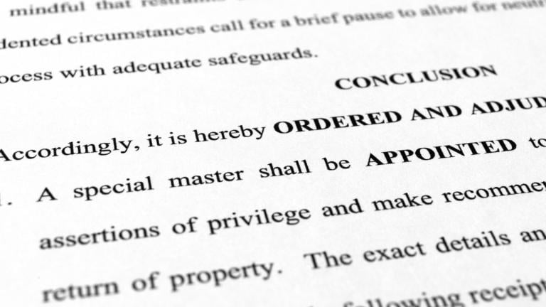 A page from the order granting a request by former President Donald Trump's legal team to appoint a special master to review documents seized by the FBI during a search of his Mar-a-Lago estate is photographed Monday, Sept. 5, 2022. (AP Photo / Jon Elswick)