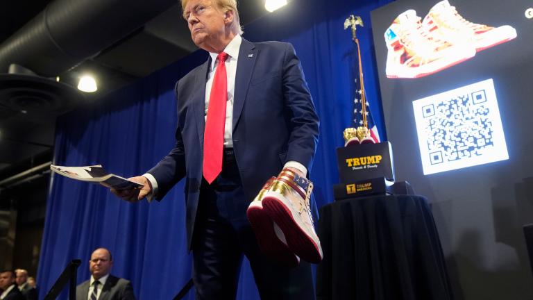 Donald Trump hold a Playboy magazine and gold Trump sneakers at Sneaker Con Philadelphia, an event popular among sneaker collectors, in Philadelphia, Saturday, Feb. 17, 2024. (AP Photo/Manuel Balce Ceneta, File)