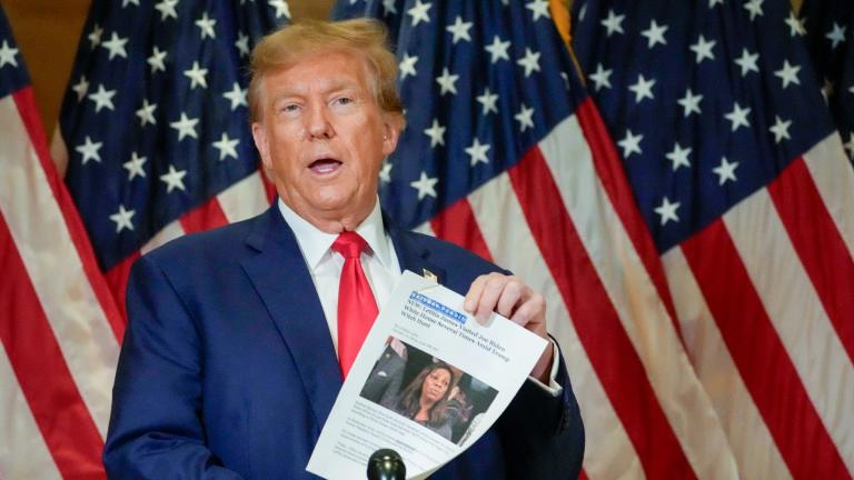 Former President Donald Trump holds up a copy of a story featuring New York Attorney General Letitia James while speaking during a news conference, Jan. 11, 2024, in New York. (AP Photo / Mary Altaffer, File)