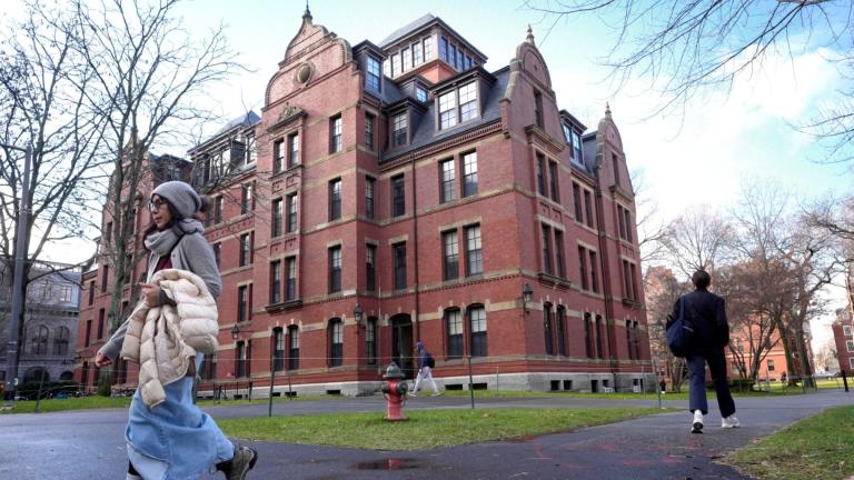 FILE - People walk between buildings on Harvard University campus, Dec. 17, 2024, in Cambridge, Mass. (AP Photo / Steven Senne, File)