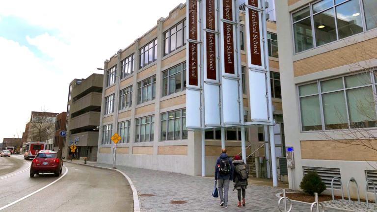 Pedestrians make their way past a building housing the Warren Alpert Medical School of Brown University, Jan. 30, 2019, in Providence, R.I. (AP Photo / Jennifer McDermott, File)