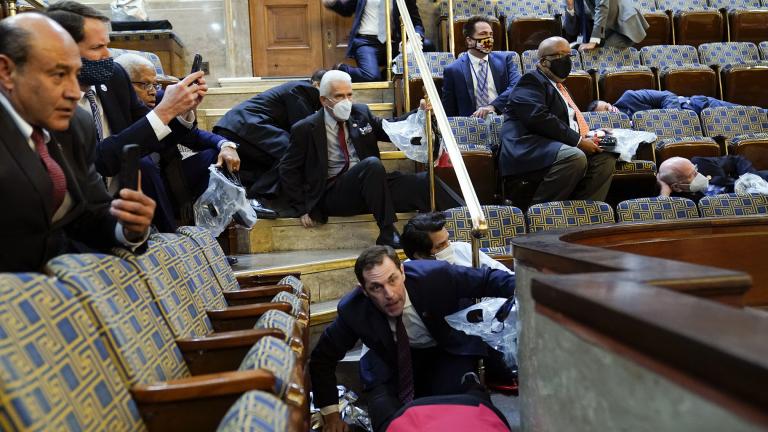 In this Jan. 6, 2021, file photo people shelter in the House gallery as rioters try to break into the House Chamber at the U.S. Capitol. (AP Photo / Andrew Harnik, File)