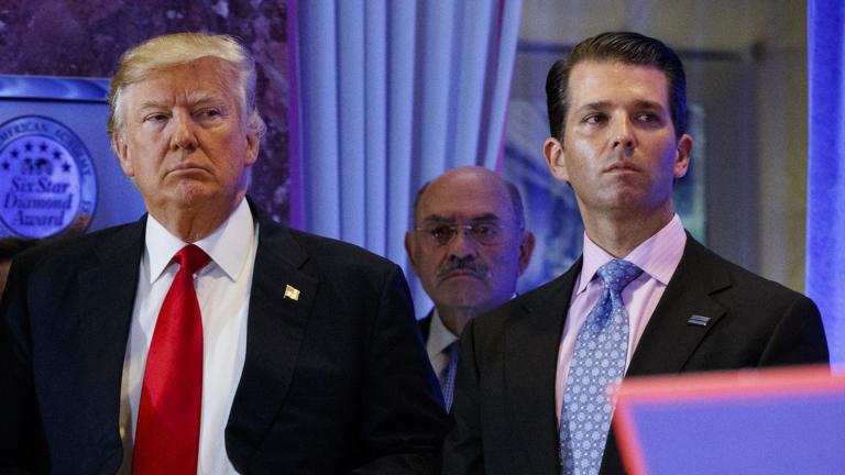 In this Jan. 11, 2017, shows President-elect Donald Trump, left, his chief financial officer Allen Weisselberg, center, and his son Donald Trump Jr., right, attend a news conference in the lobby of Trump Tower in New York. (AP Photo / Evan Vucci, File)