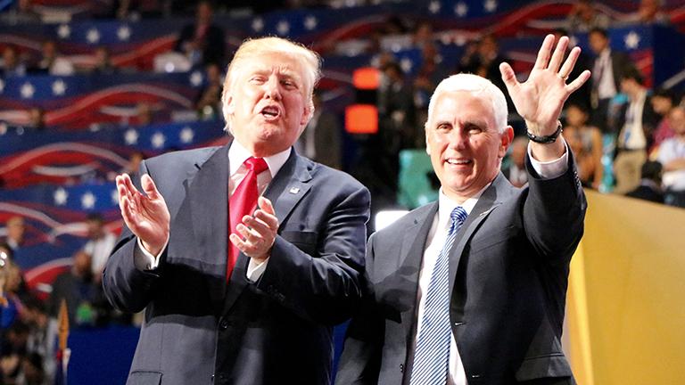 Republican presidential nominee Donald Trump and vice presidential nominee Gov. Mike Pence greet the crowd at the front of the stage. (Evan Garcia / Chicago Tonight)