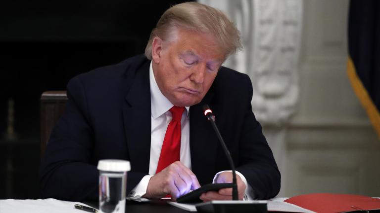 In this Thursday, June 18, 2020 file photo, President Donald Trump looks at his phone during a roundtable with governors on the reopening of America’s small businesses, in the State Dining Room of the White House in Washington. (AP Photo / Alex Brandon, File)