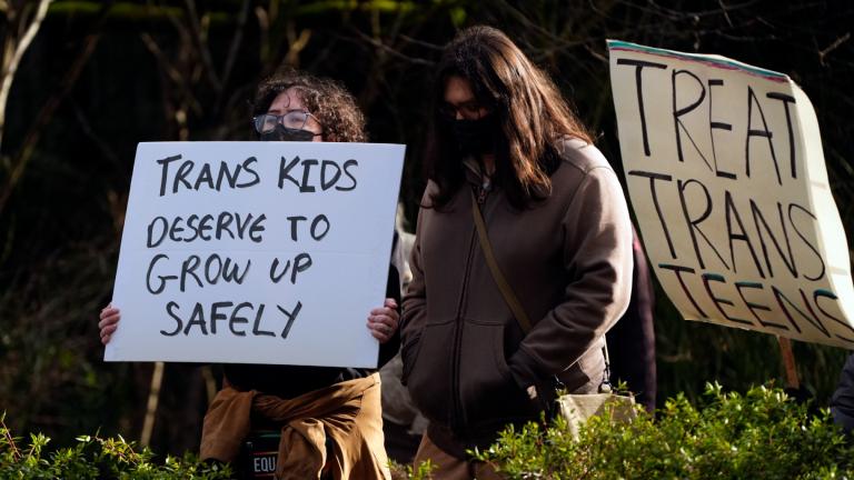 FILE - People wave signs to passing cars during a pro-transgender rights protest outside of Seattle Children's Hospital after the institution postponed some gender-affirming surgeries for minors following an executive order by President Donald Trump, Sunday, Feb. 9, 2025, in Seattle. (Lindsey Wasson / AP Photo, File)