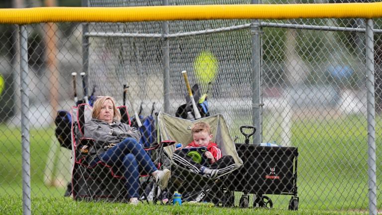 Karli Casamento, watches of her 15-year-old son, Jax's youth baseball game with her son seven-year-old Colt in Aston, Pa., Tuesday, May 27, 2025. (AP Photo / Matt Rourke)