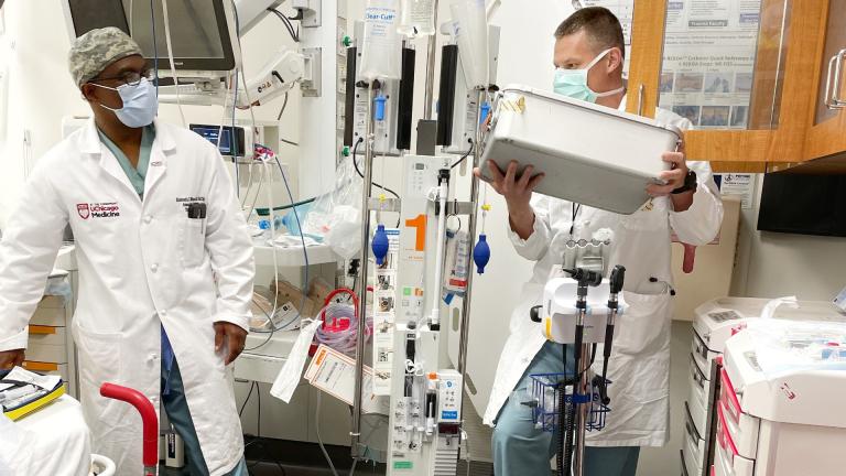 Dr. Kenneth Wilson, left, medical director of University of Chicago Medicine’s trauma center, works with Lt. Col. Timothy Plackett, DO, a trauma surgeon from the U.S. Army who is spending the next three years working at the Hyde Park academic medical center. (Credit: University of Chicago Medicine)
