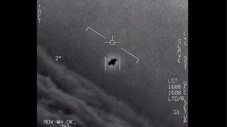 The image from video provided by the Department of Defense labelled Gimbal, from 2015, an unexplained object is seen at center as it is tracked as it soars high along the clouds, traveling against the wind. (Department of Defense via AP)