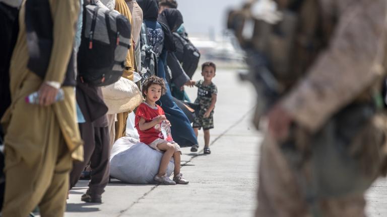 In this Aug. 22, 2021, image provided by the U.S. Marine Corps, a child waits with her family to board a U.S. Air Force Boeing C-17 Globemaster III during an evacuation at Hamid Karzai International Airport in Kabul, Afghanistan. (Sgt. Samuel Ruiz/U.S. Marine Corps via AP)