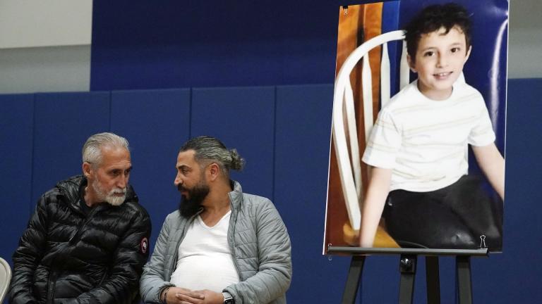 Wadee Alfayoumi's father, Oday Al Fayoume, seated right, and his uncle Mahmoud Yousef attend a vigil for Wadee at Prairie Activity and Recreation center in Plainfield, Ill., Oct. 17, 2023. (AP Photo/Nam Y. Huh, File)