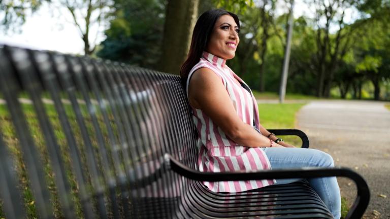 Julieth Luna Garcia, a transgender woman from El Salvador, sits on a bench as she looks at trees at Horner Park in Chicago, Monday, Sept. 30, 2024. (Nam Y. Huh / AP Photo)