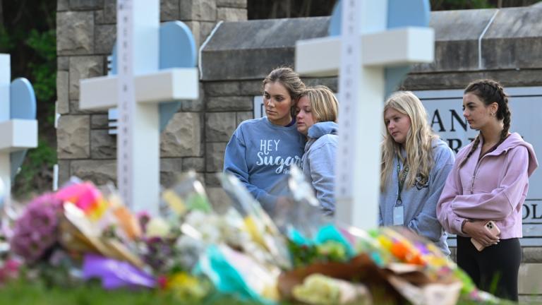 Students at a nearby school pay respects at a memorial for the people who were killed, at an entry to Covenant School, Tuesday, March 28, 2023, in Nashville, Tenn. (AP Photo / John Amis, File)