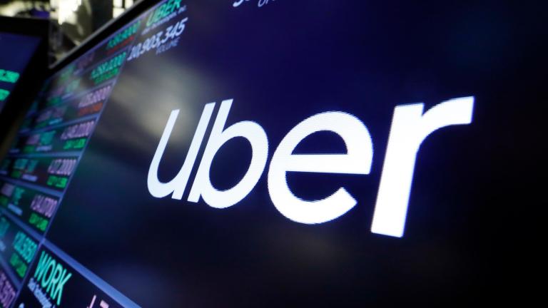 FILE - The Uber logo appears above a trading post on the floor of the New York Stock Exchange, Aug. 16, 2019. (Richard Drew / AP Photo, File)