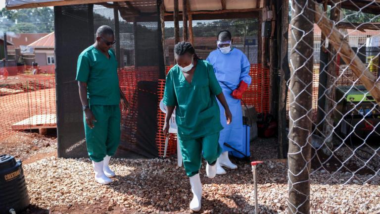 A medical attendant disinfects the rubber boots of a medical officer before leaving the Ebola isolation section of Mubende Regional Referral Hospital, in Mubende, Uganda Thursday, Sept. 29, 2022. (AP Photo / Hajarah Nalwadda)