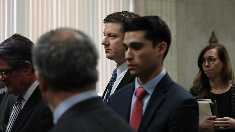 Chicago police Officer Jason Van Dyke, foreground, stands in front of Judge Vincent Gaughan at the Leighton Criminal Court Building in Chicago on Wednesday, March 28, 2018. (Nancy Stone / Chicago Tribune / Pool) Chicago police Officer Jason Van Dyke, foreground, stands in front of Judge Vincent Gaughan at the Leighton Criminal Court Building in Chicago on Wednesday, March 28, 2018. (Nancy Stone / Chicago Tribune / Pool)