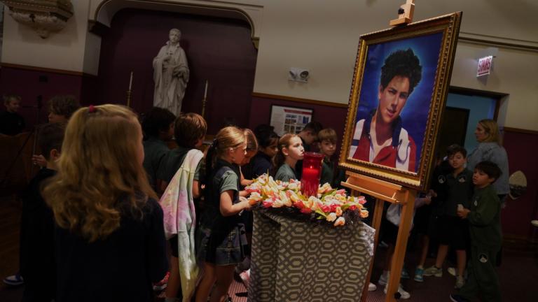 Students of St. John Berchmans' school walk past a photo of Blessed Carlo Acutis, who will be canonized a saint by Pope Leo XIV, after Mass at Blessed Carlo Acutis Parish, on Wednesday, Sept. 3, 2025, in Chicago. (AP Photo/Jessie Wardarski)