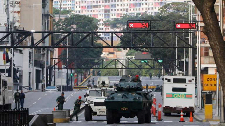 National Guard armored vehicles block an avenue leading to Miraflores presidential palace in Caracas, Venezuela, Saturday, Jan. 3, 2026. (AP Photo/Cristian Hernandez)