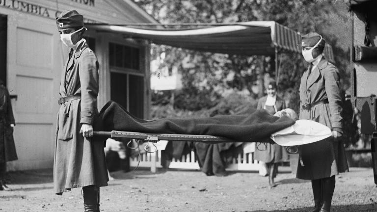 This photo made available by the Library of Congress shows a demonstration at the Red Cross Emergency Ambulance Station in Washington during the influenza pandemic of 1918. (Library of Congress via AP, File)