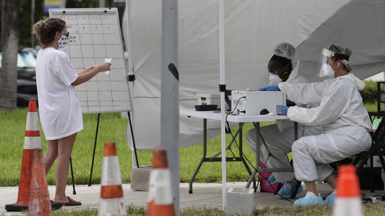 In this Friday, July 17, 2020 file photo, health care workers take information from people in line at a walk-up COVID-19 testing site during the coronavirus pandemic in Miami Beach, Fla. (AP Photo / Lynne Sladky) In this Friday, July 17, 2020 file photo, health care workers take information from people in line at a walk-up COVID-19 testing site during the coronavirus pandemic in Miami Beach, Fla. (AP Photo / Lynne Sladky)