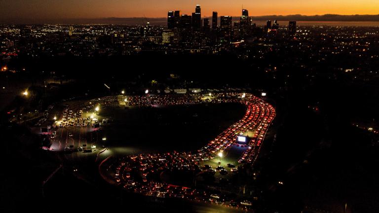 In this Nov 18, 2020, file photo, motorists wait in long lines to take a coronavirus test in a parking lot at Dodger Stadium in Los Angeles. (AP Photo/Ringo H.W. Chiu, File)