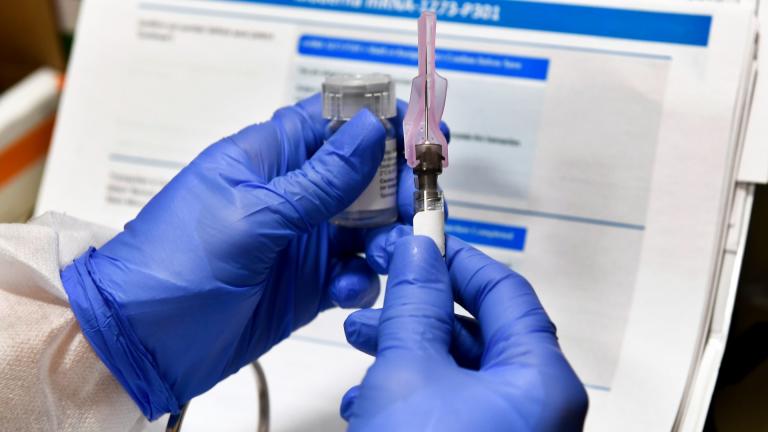 In this July 27, 2020, file photo, nurse Kathe Olmstead prepares a shot that is part of a possible COVID-19 vaccine, developed by the National Institutes of Health and Moderna Inc., in Binghamton, N.Y. (AP Photo / Hans Pennink, File)