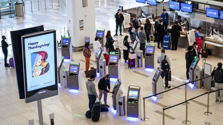 In this Nov. 25, 2020, file photo, travelers wait to check-in for their flights ahead of Thanksgiving at LaGuardia Airport, in the Queens borough of New York. (AP Photo / John Minchillo, File) In this Nov. 25, 2020, file photo, travelers wait to check-in for their flights ahead of Thanksgiving at LaGuardia Airport, in the Queens borough of New York. (AP Photo / John Minchillo, File)