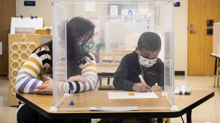 In this Jan. 11, 2021 file photo, pre-kindergarten teacher Sarah McCarthy works with a student at Dawes Elementary in Chicago. (Ashlee Rezin Garcia / Chicago Sun-Times via AP, Pool, File) In this Jan. 11, 2021 file photo, pre-kindergarten teacher Sarah McCarthy works with a student at Dawes Elementary in Chicago. (Ashlee Rezin Garcia / Chicago Sun-Times via AP, Pool, File)